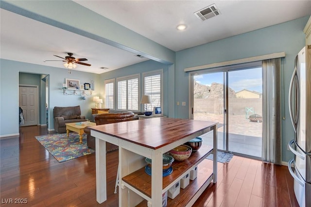 dining area featuring plenty of natural light, dark wood-style floors, and visible vents