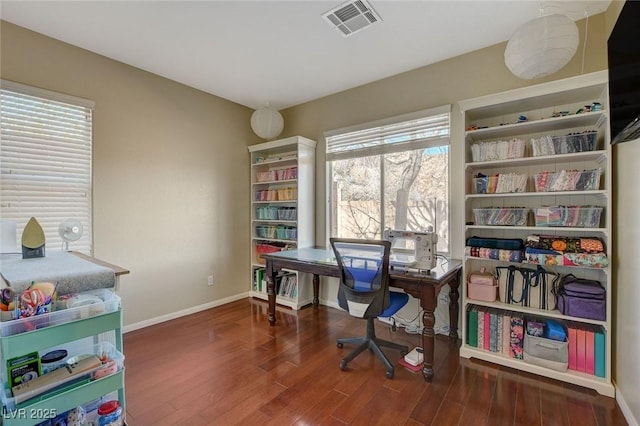 office featuring visible vents, baseboards, and wood finished floors