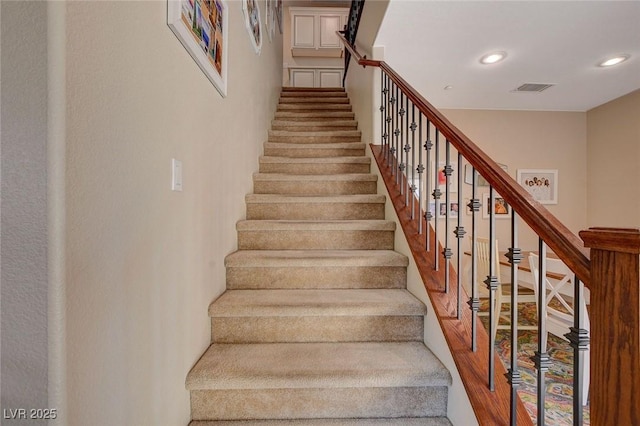 stairs with recessed lighting and visible vents