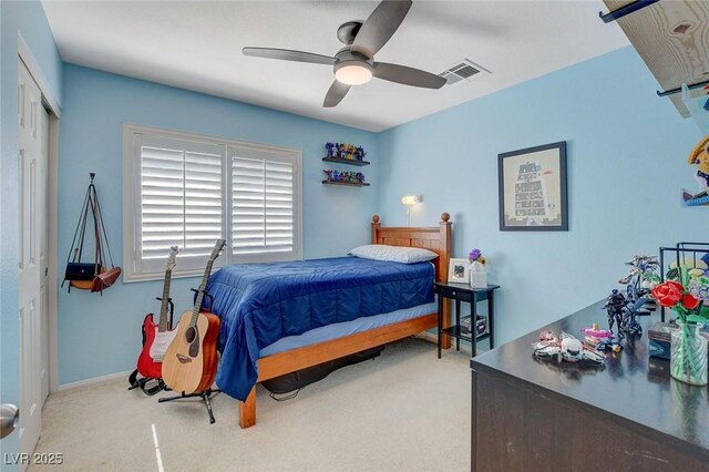 carpeted bedroom with visible vents, a closet, and ceiling fan