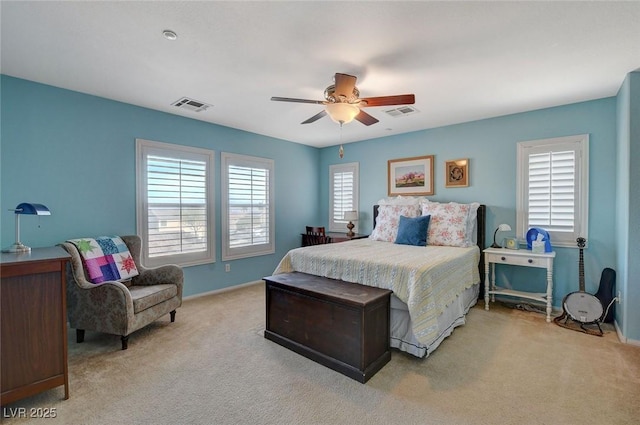 carpeted bedroom featuring visible vents, baseboards, and ceiling fan