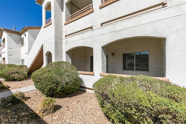 property entrance with stucco siding