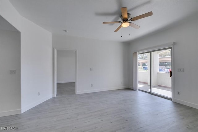 empty room featuring ceiling fan, baseboards, and wood finished floors