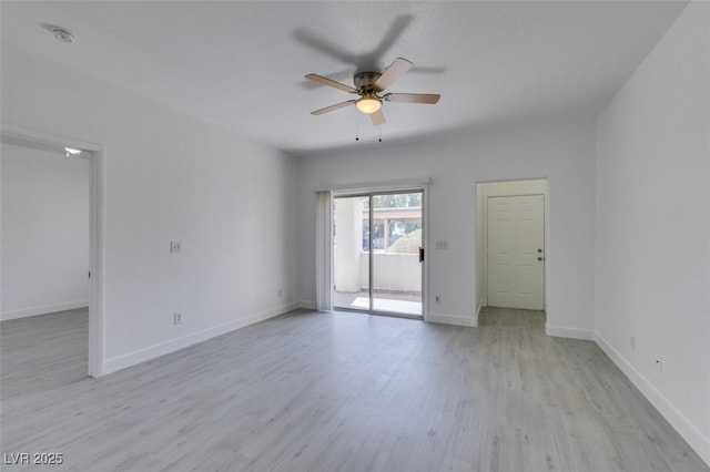 unfurnished room featuring baseboards, light wood finished floors, and ceiling fan