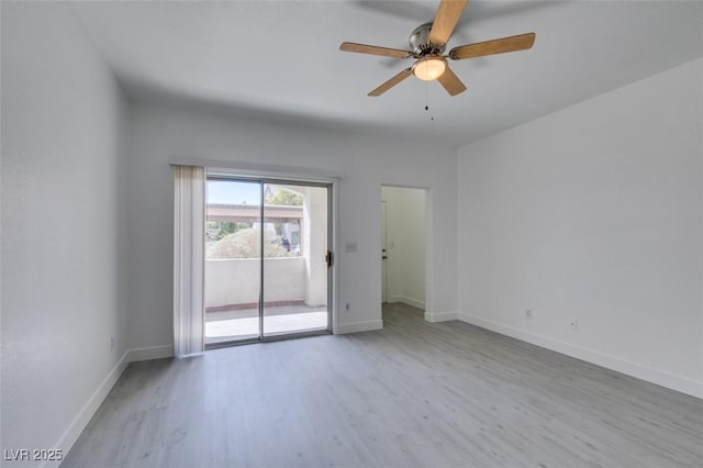 spare room with ceiling fan, baseboards, and wood finished floors