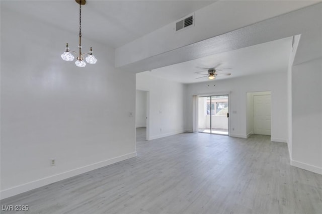 empty room featuring light wood finished floors, visible vents, ceiling fan with notable chandelier, and baseboards