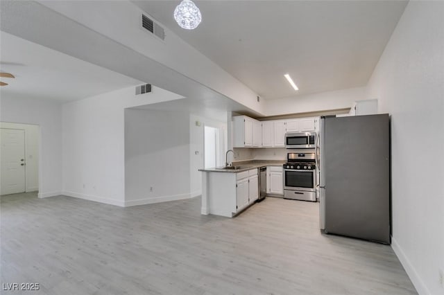 kitchen with white cabinets, light wood-style floors, visible vents, and stainless steel appliances