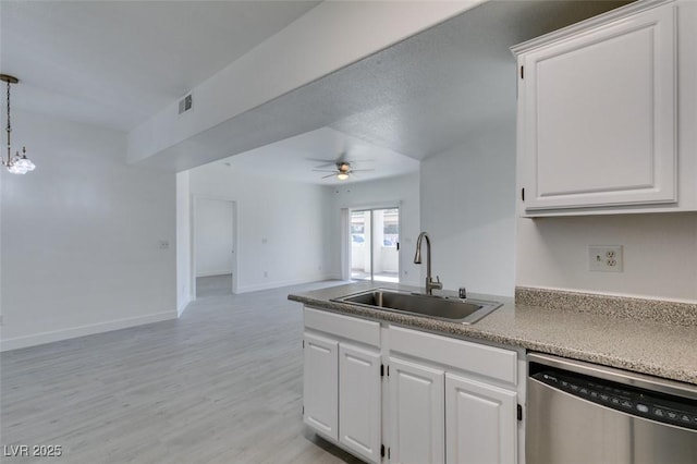 kitchen featuring open floor plan, ceiling fan with notable chandelier, stainless steel dishwasher, white cabinets, and a sink