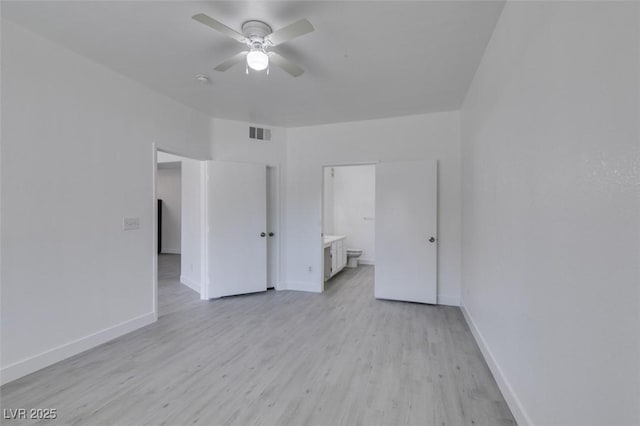 unfurnished bedroom featuring ensuite bath, baseboards, visible vents, and light wood finished floors