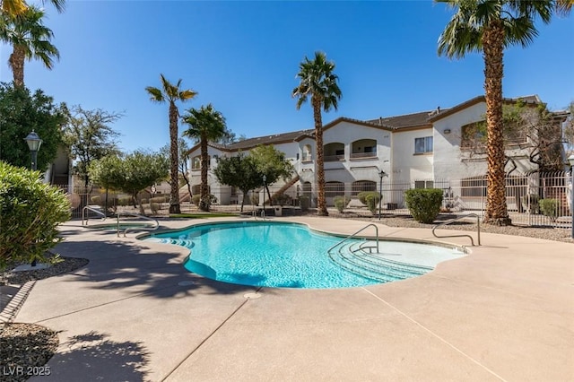 pool with fence and a patio area