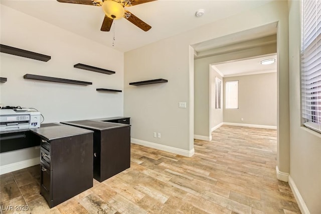 home office featuring light wood-style flooring, baseboards, and ceiling fan