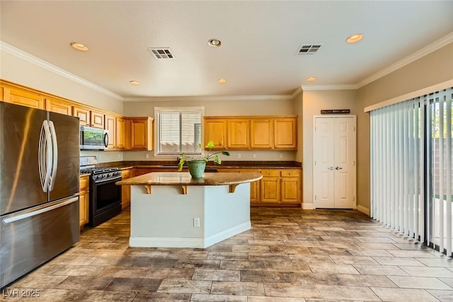 kitchen with a breakfast bar, visible vents, a kitchen island, and stainless steel appliances