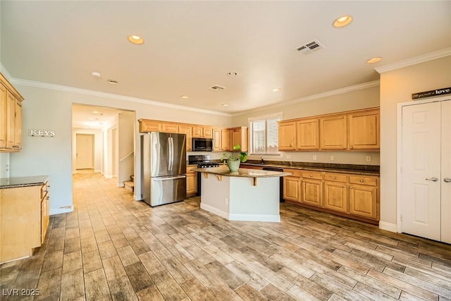 kitchen with light wood finished floors, a kitchen island, crown molding, recessed lighting, and appliances with stainless steel finishes