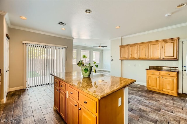 kitchen featuring visible vents, crown molding, baseboards, wood tiled floor, and light stone counters