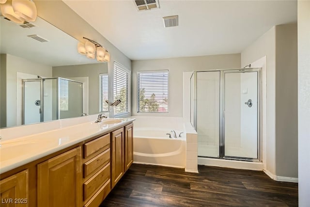 bathroom featuring visible vents, a stall shower, and a garden tub