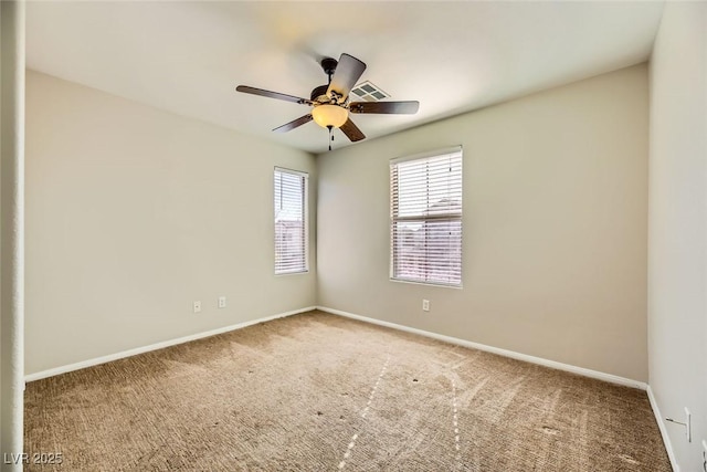 spare room featuring visible vents, baseboards, ceiling fan, and carpet flooring