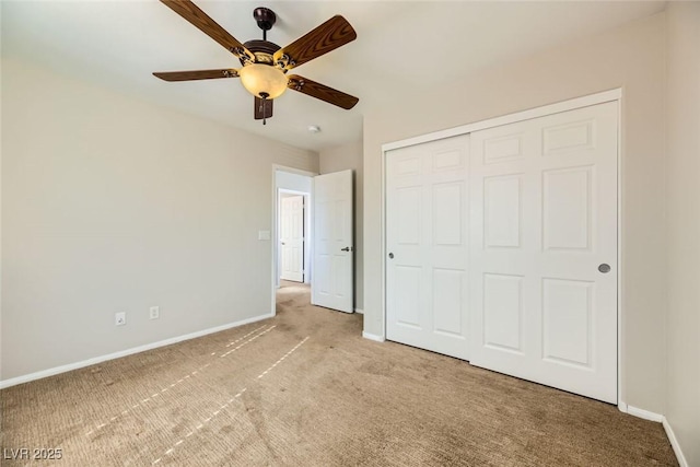 unfurnished bedroom featuring baseboards, carpet floors, a closet, and ceiling fan