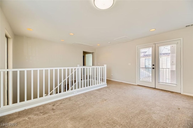 carpeted spare room with recessed lighting, french doors, baseboards, and visible vents