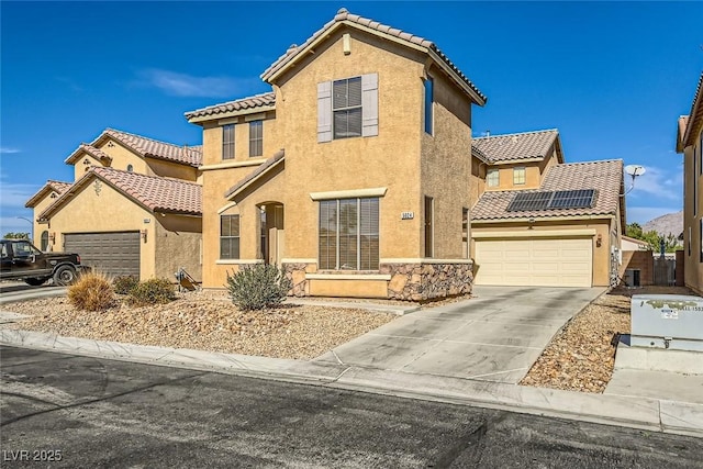 mediterranean / spanish-style house with stucco siding, concrete driveway, and a tiled roof