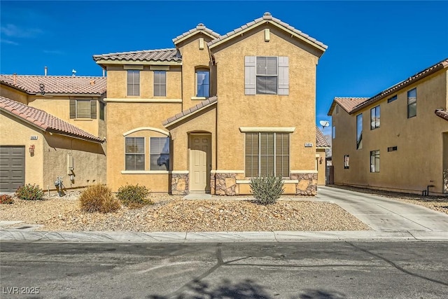 view of front of property with stone siding, stucco siding, a tiled roof, and driveway