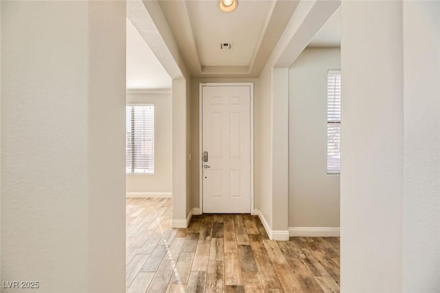 entrance foyer with visible vents, baseboards, and light wood-style floors