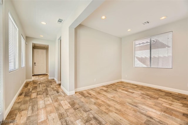 spare room with light wood-style flooring, recessed lighting, baseboards, and visible vents