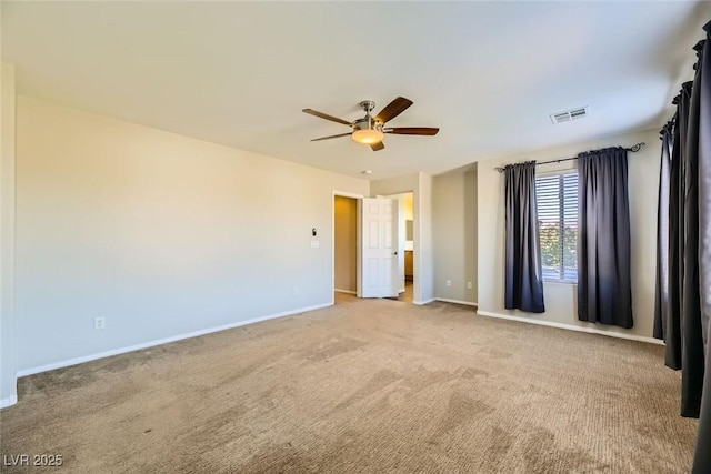 unfurnished bedroom featuring light colored carpet, baseboards, visible vents, and ceiling fan