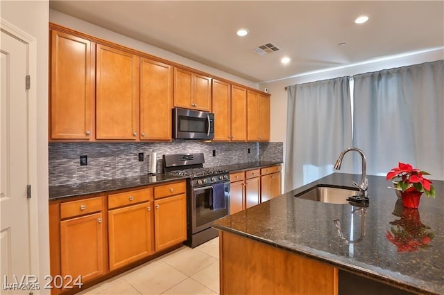 kitchen with light tile patterned floors, visible vents, a sink, stainless steel appliances, and backsplash