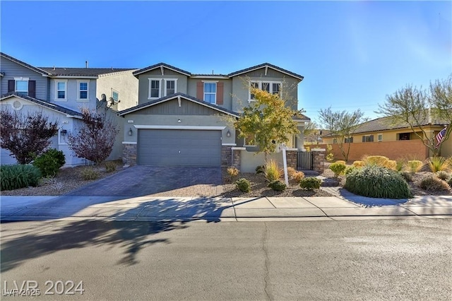 craftsman inspired home with stone siding, decorative driveway, and fence