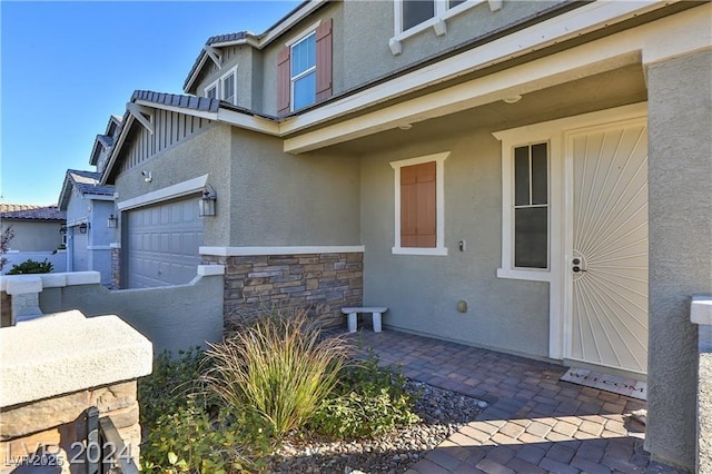 doorway to property with stone siding and stucco siding