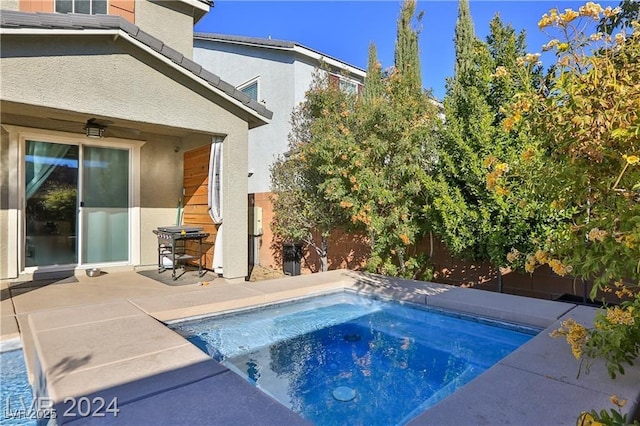 view of swimming pool featuring a patio, an in ground hot tub, and a fenced backyard