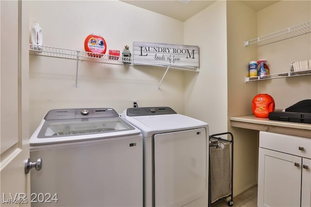 laundry area with cabinet space and separate washer and dryer