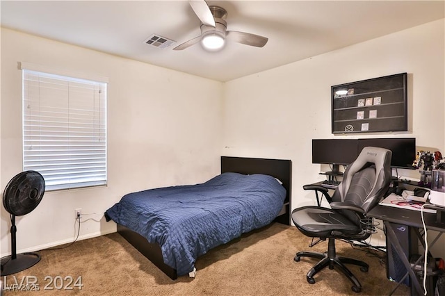 carpeted bedroom featuring visible vents, baseboards, and ceiling fan