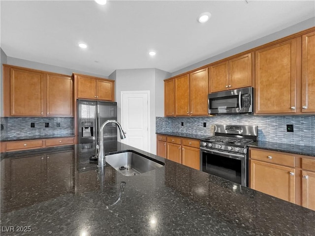 kitchen with a sink, brown cabinetry, and stainless steel appliances