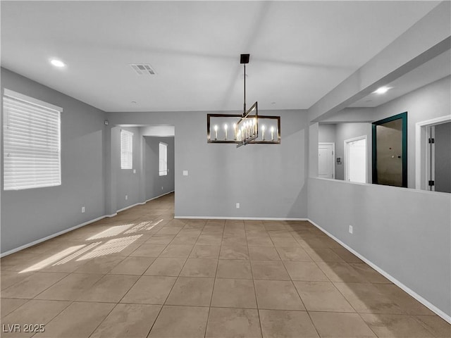 interior space featuring tile patterned flooring, recessed lighting, visible vents, and baseboards