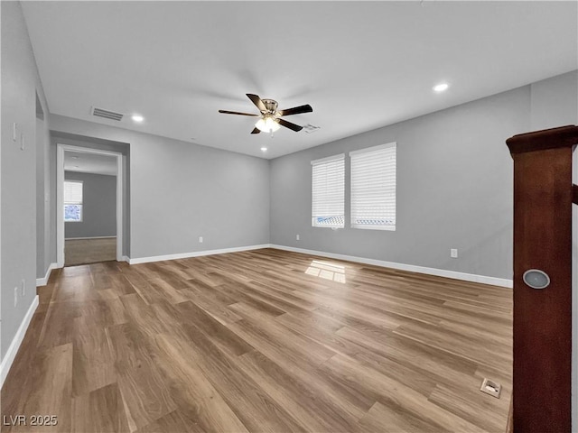 empty room featuring recessed lighting, baseboards, light wood finished floors, and ceiling fan