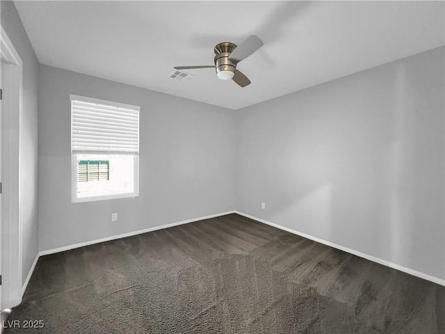 unfurnished room featuring visible vents, baseboards, a ceiling fan, and dark colored carpet