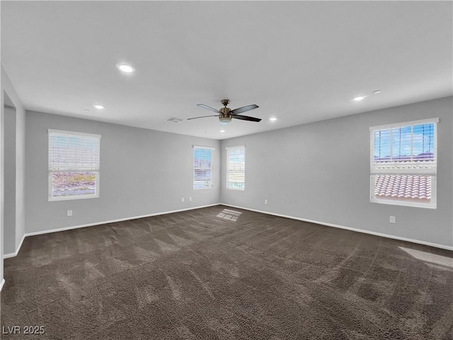 empty room with dark colored carpet, visible vents, baseboards, and recessed lighting