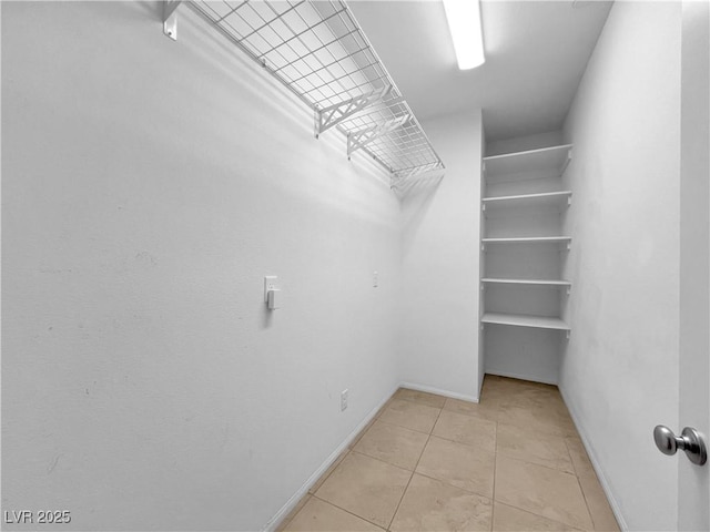 walk in closet featuring light tile patterned floors