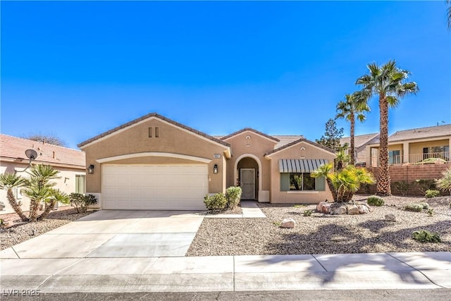 view of front of property with a tile roof, concrete driveway, a garage, and stucco siding