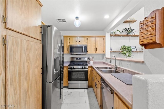 kitchen with visible vents, a sink, light countertops, appliances with stainless steel finishes, and marble finish floor