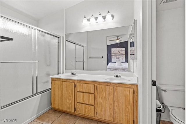 bathroom featuring a sink, connected bathroom, combined bath / shower with glass door, and tile patterned flooring