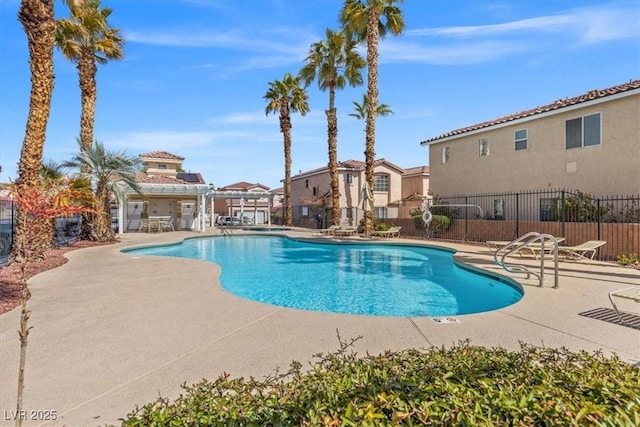 community pool featuring a patio and fence