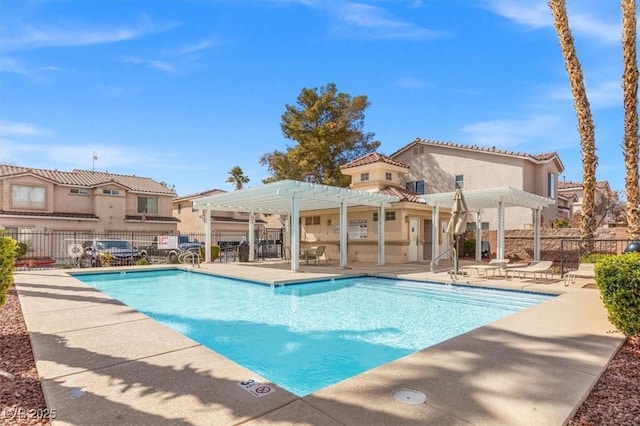 pool featuring a patio, fence, and a pergola