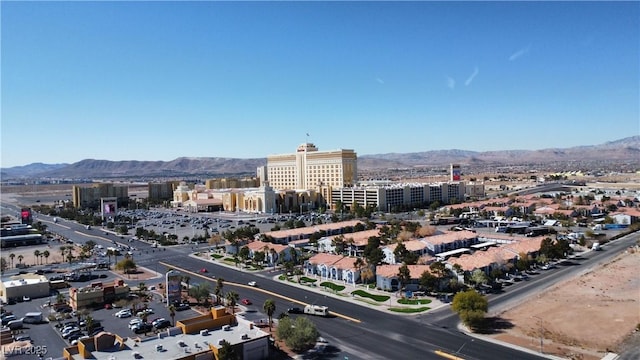 drone / aerial view featuring a mountain view and a city view