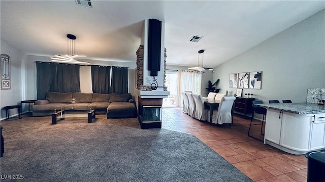 living area with visible vents, lofted ceiling, carpet floors, and a chandelier