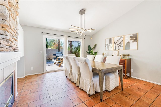 124 Beach Oak Ave, Henderson, NV 89002 - dining area featuring baseboards, lofted ceiling, a fireplace, and light tile patterned floors