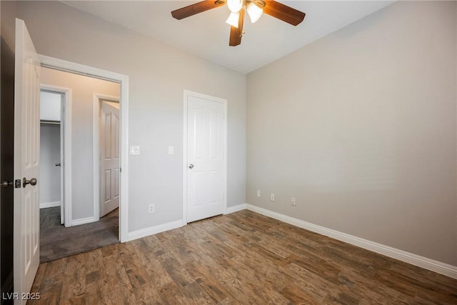 unfurnished bedroom with a ceiling fan, baseboards, and wood finished floors