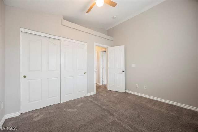 unfurnished bedroom with ceiling fan, baseboards, lofted ceiling, carpet flooring, and a closet