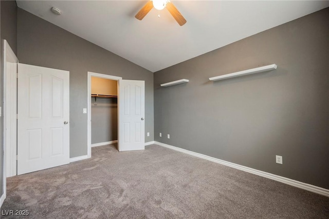 unfurnished bedroom featuring lofted ceiling, a ceiling fan, a closet, carpet, and baseboards